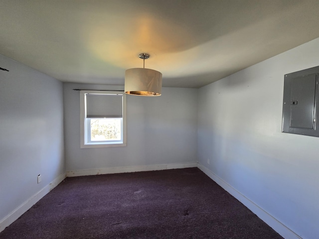 carpeted spare room with baseboards and electric panel