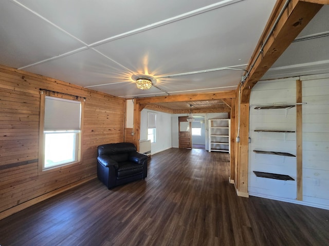 unfurnished room featuring wood walls and dark wood finished floors