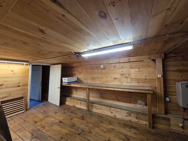 below grade area with wood-type flooring, wood ceiling, and wooden walls