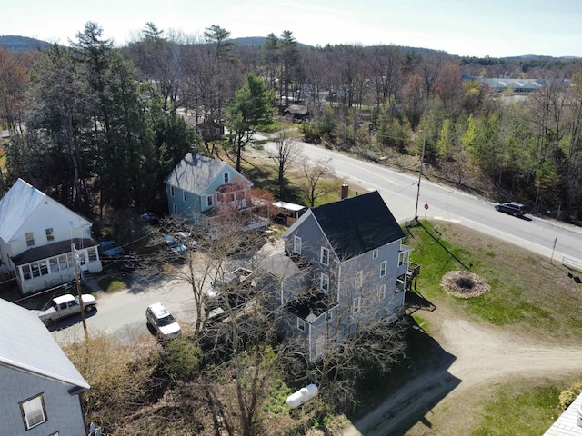 drone / aerial view featuring a wooded view