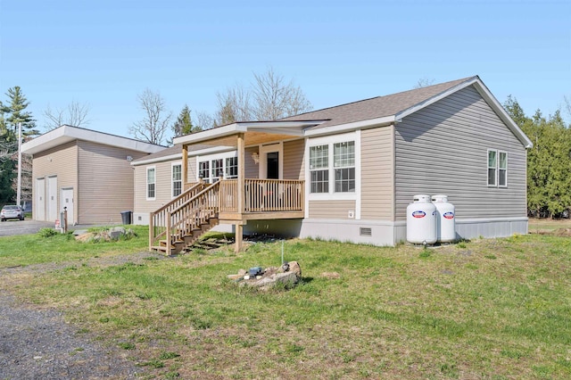 manufactured / mobile home featuring stairs, crawl space, and a front yard