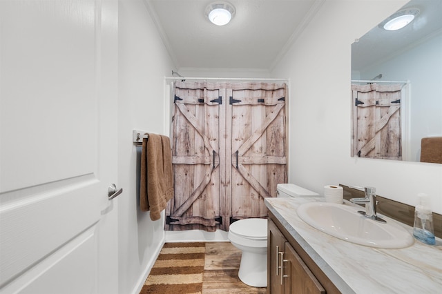 bathroom with vanity, ornamental molding, wood finished floors, curtained shower, and toilet