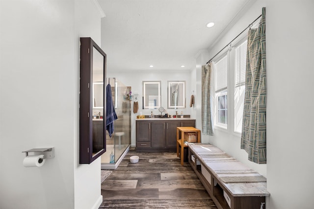 full bath featuring crown molding, a shower stall, recessed lighting, and wood finished floors