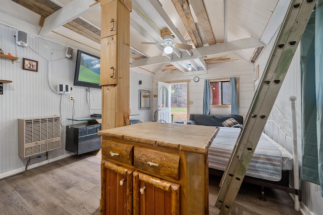 interior space featuring ceiling fan, beamed ceiling, and wood finished floors