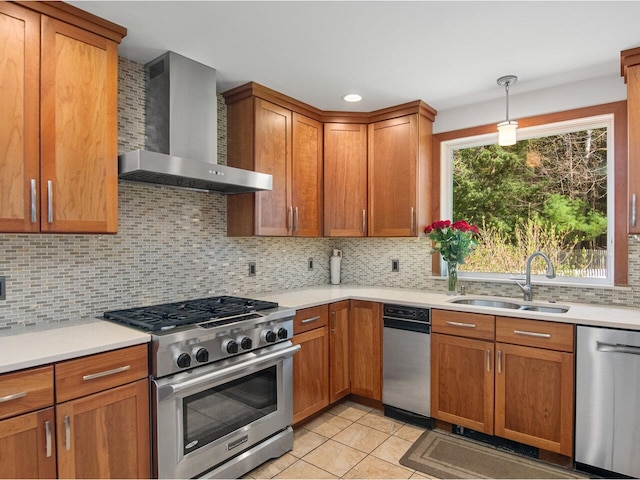 kitchen featuring light tile patterned flooring, appliances with stainless steel finishes, a sink, wall chimney exhaust hood, and decorative backsplash