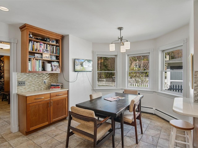 dining room featuring a notable chandelier and baseboard heating