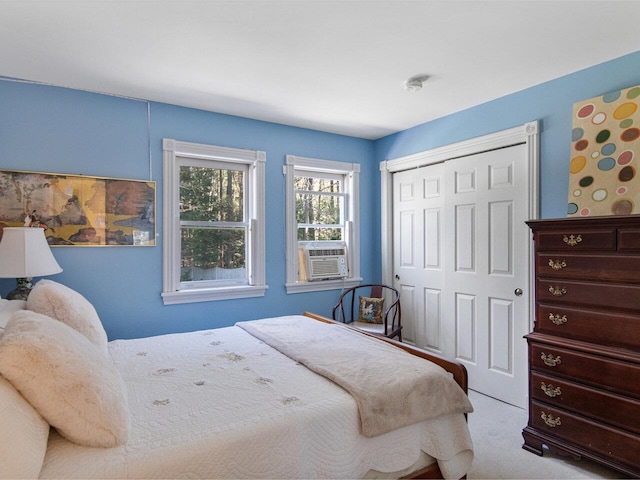 carpeted bedroom featuring cooling unit and a closet