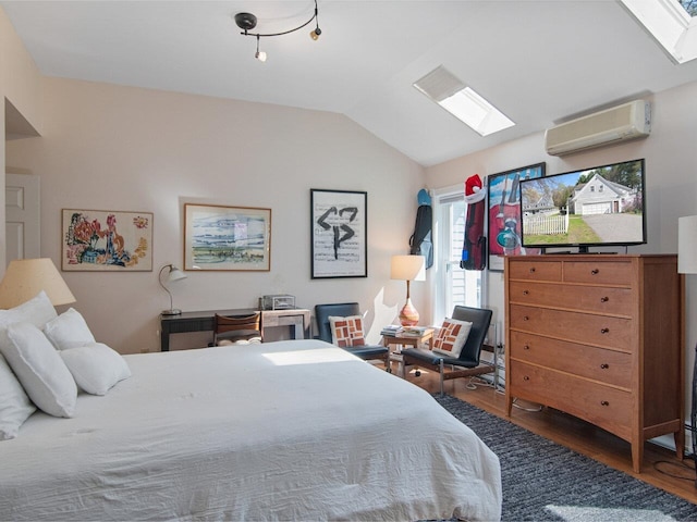 bedroom featuring a wall mounted AC, wood finished floors, and vaulted ceiling with skylight