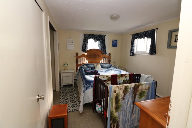 bedroom with crown molding and concrete flooring