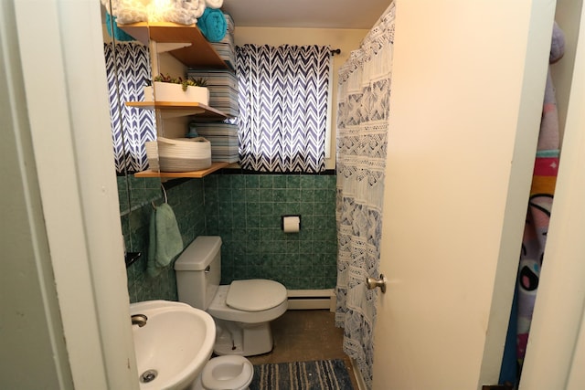 bathroom featuring curtained shower, toilet, tile walls, a baseboard heating unit, and a sink