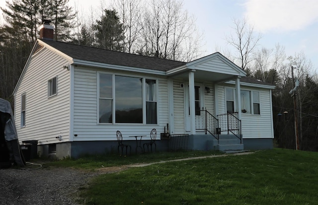 view of front of home featuring a front yard and a chimney