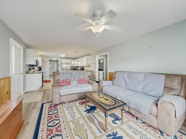 living room with light wood-style floors and ceiling fan