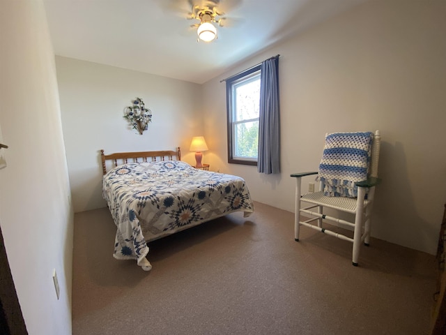 bedroom with a ceiling fan and carpet