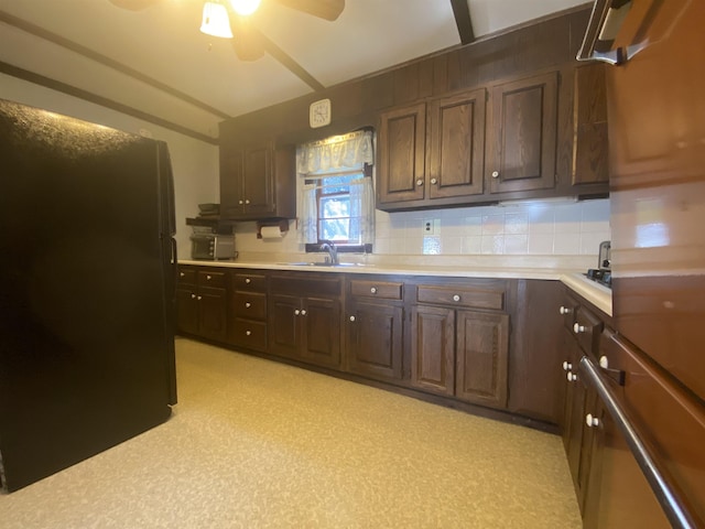 kitchen featuring freestanding refrigerator, a sink, ceiling fan, and light countertops