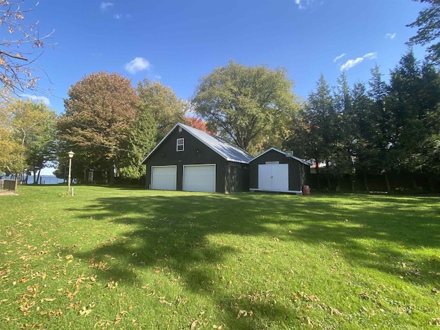 detached garage with a storage shed