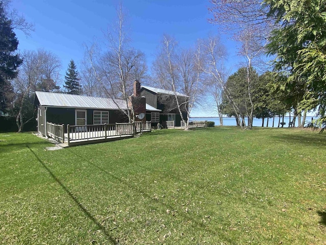 view of yard featuring a deck with water view