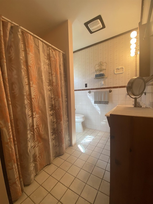 bathroom featuring tile patterned flooring, wallpapered walls, toilet, and vanity