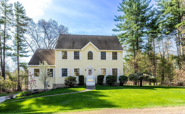 colonial-style house with a front lawn