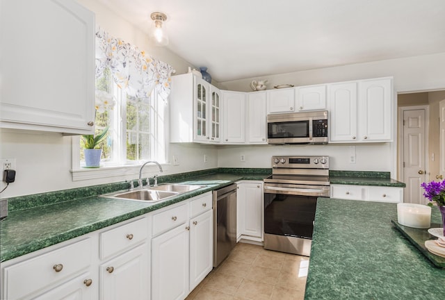 kitchen featuring a sink, white cabinetry, appliances with stainless steel finishes, and dark countertops