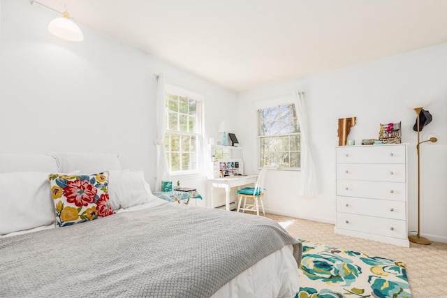 bedroom with baseboards, carpet, and a baseboard heating unit