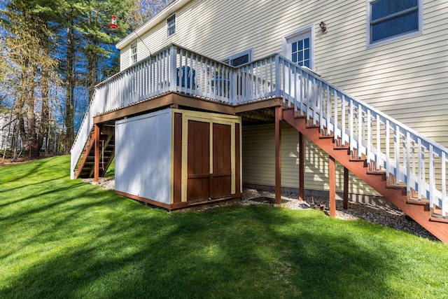 back of property with a wooden deck, stairs, and a lawn