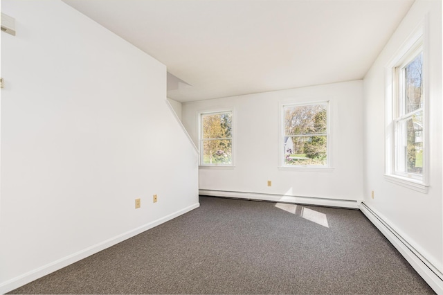 empty room featuring baseboards, a baseboard radiator, a baseboard heating unit, and dark colored carpet