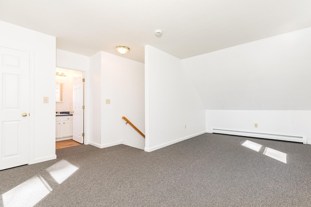 carpeted spare room with baseboards and a baseboard radiator