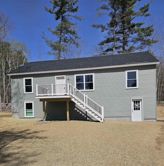 view of front facade featuring a wooden deck and stairs