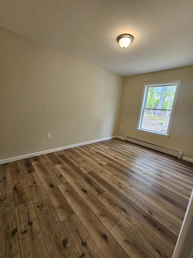 310 Emery Mills Rd, Shapleigh, ME 04076 - empty room featuring baseboard heating, dark wood-style flooring, and baseboards