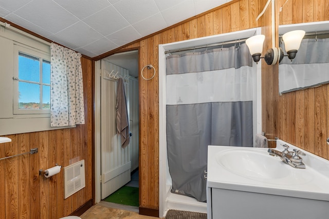 full bathroom with wooden walls, vanity, a shower with shower curtain, heating unit, and lofted ceiling