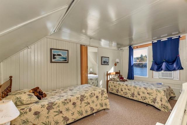 bedroom with carpet flooring, lofted ceiling, and wood walls