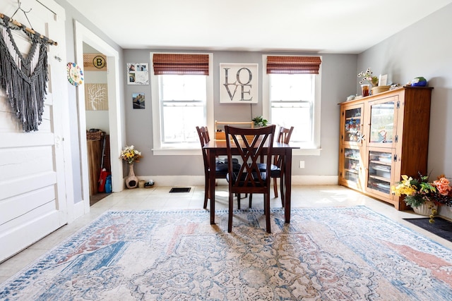 dining room with baseboards, a wealth of natural light, tile patterned flooring, and visible vents