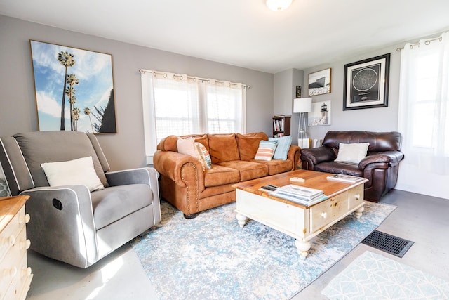 living area with concrete flooring and visible vents
