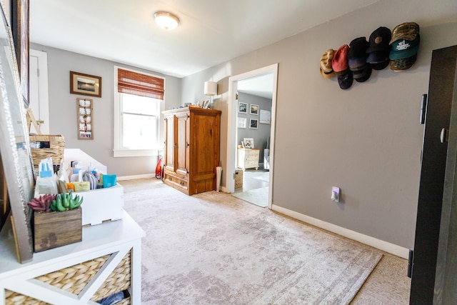 bedroom featuring baseboards and carpet