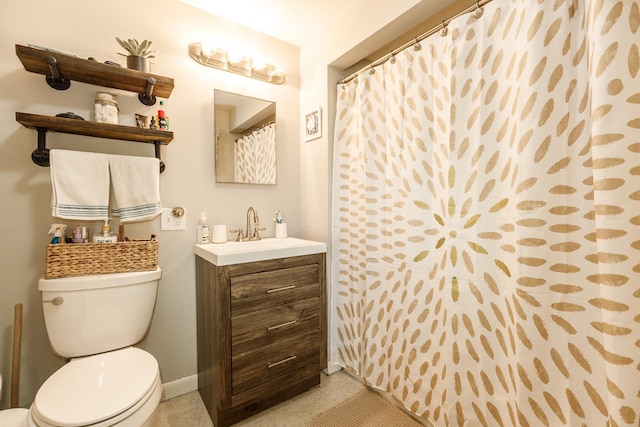full bathroom with vanity, baseboards, and toilet