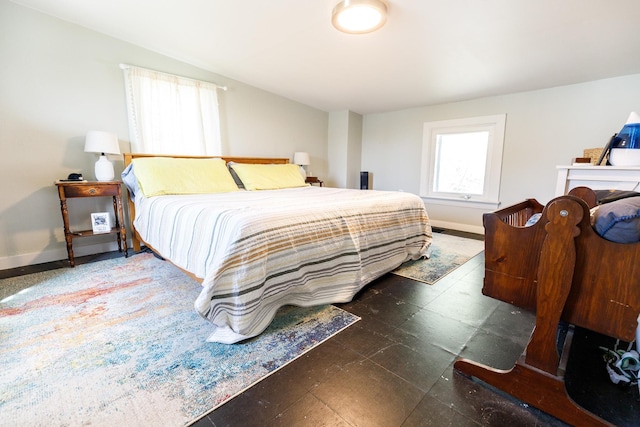 bedroom with tile patterned floors and baseboards