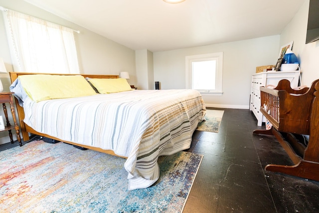 bedroom with baseboards and tile patterned floors