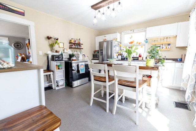 kitchen with crown molding, white cabinetry, appliances with stainless steel finishes, and visible vents