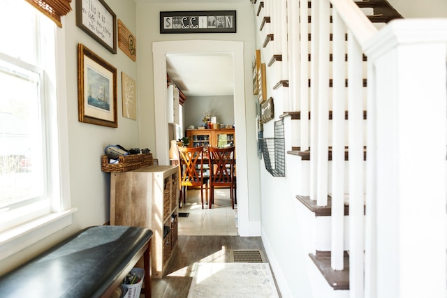 corridor featuring baseboards and visible vents