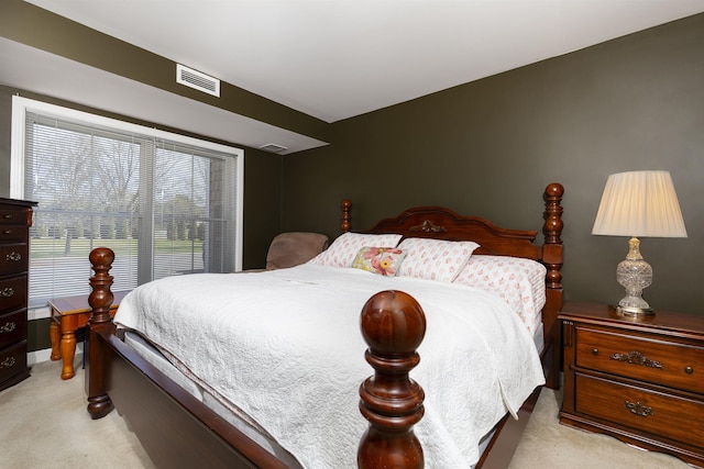 bedroom featuring visible vents and light carpet