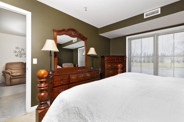 bedroom with baseboards, carpet, and visible vents