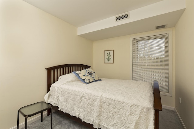 carpeted bedroom with baseboards and visible vents