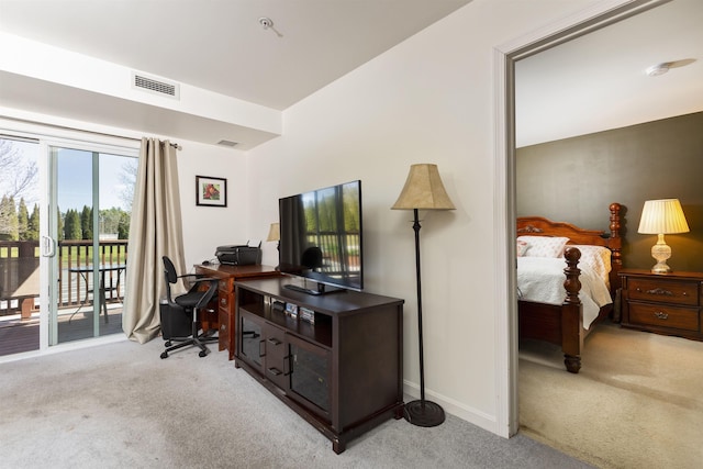 office space featuring baseboards, light carpet, and visible vents