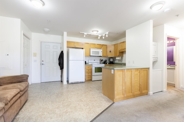 kitchen with open floor plan, a sink, a peninsula, and white appliances