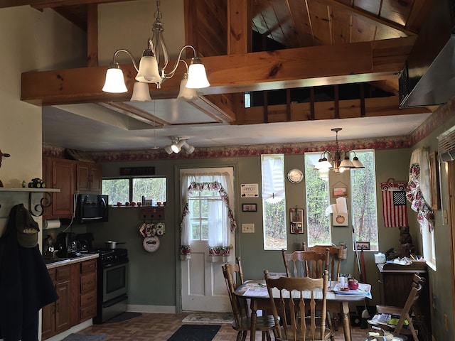 dining area with a chandelier and baseboards