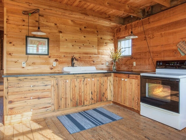 kitchen featuring range with electric cooktop, a sink, wooden ceiling, wood-type flooring, and wooden walls