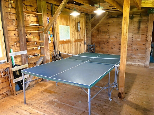 playroom featuring wooden walls and hardwood / wood-style floors