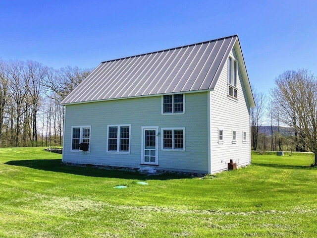 back of house with a lawn