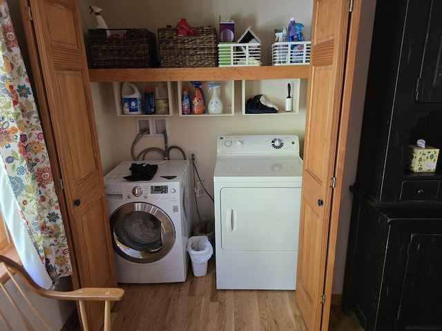 laundry room featuring independent washer and dryer, laundry area, and light wood-style flooring