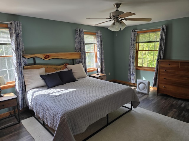 bedroom featuring baseboards, ceiling fan, and wood finished floors
